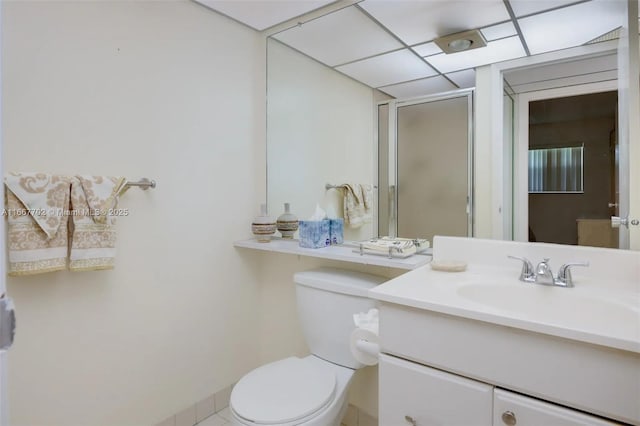 bathroom featuring vanity, a shower with door, and toilet