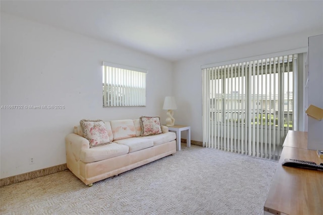 living room featuring light colored carpet and plenty of natural light