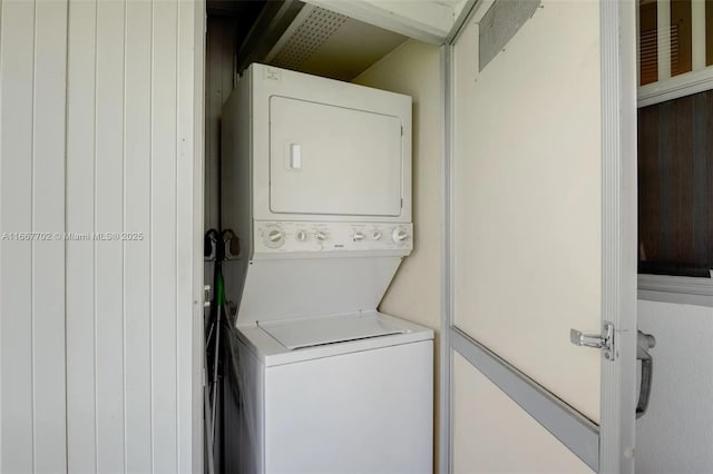 laundry room with stacked washing maching and dryer