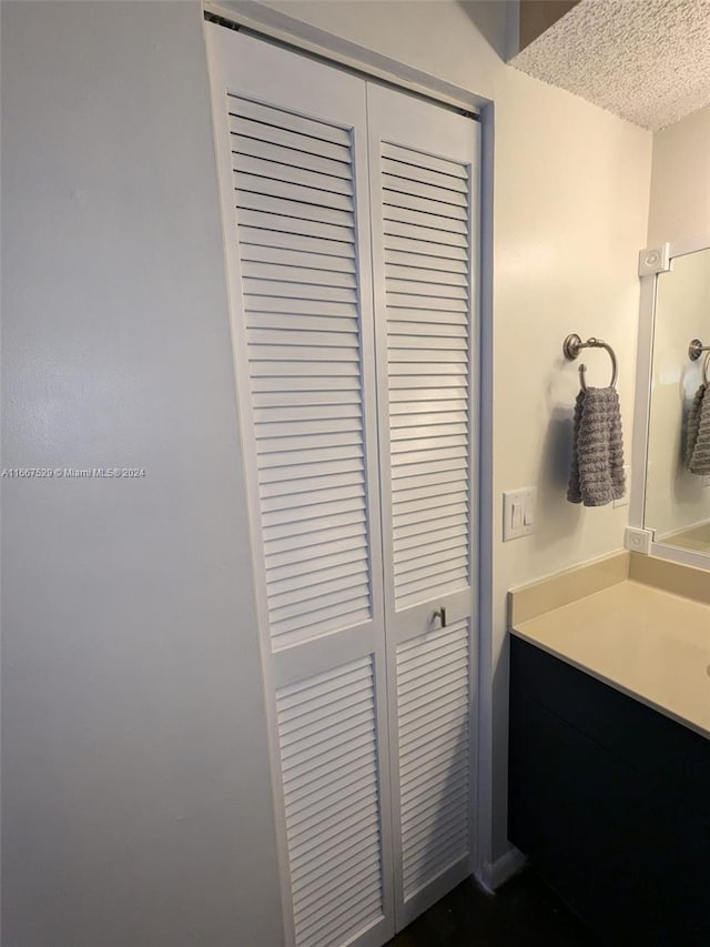 bathroom featuring a textured ceiling and vanity