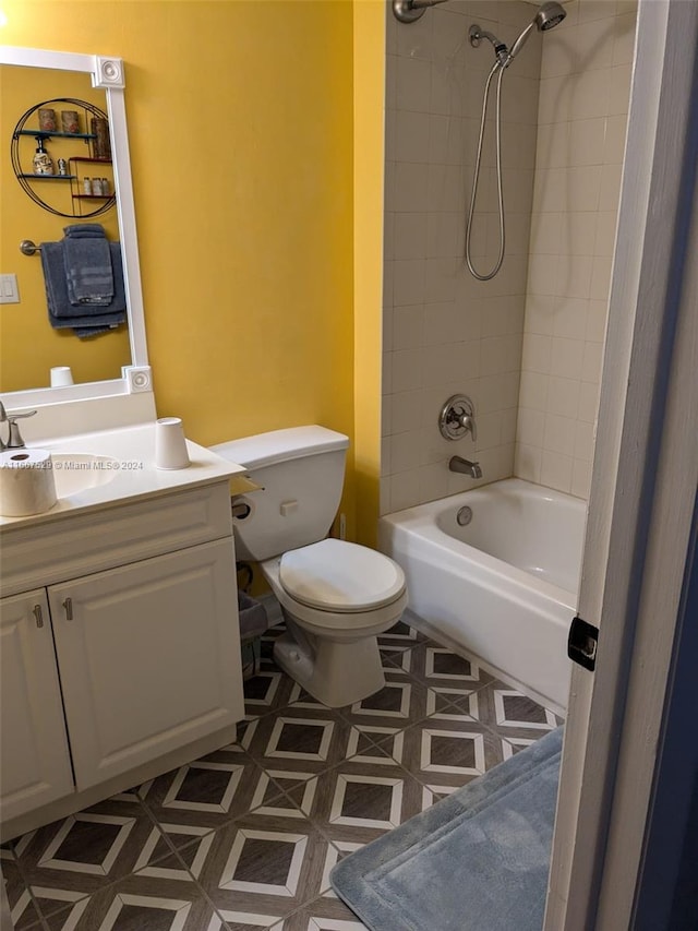 full bathroom with vanity, tiled shower / bath combo, toilet, and tile patterned flooring