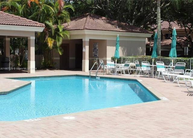 view of swimming pool featuring a patio area