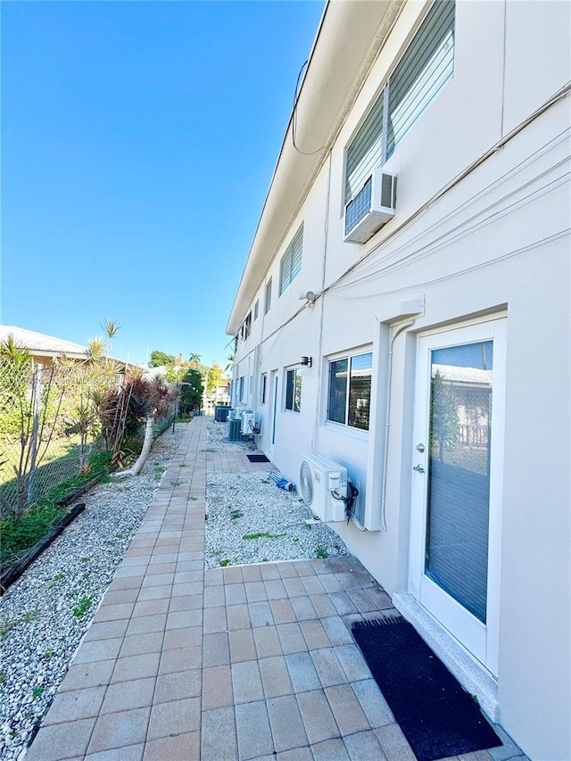 view of side of home featuring ac unit and a patio area