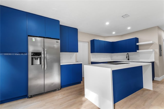 kitchen featuring a kitchen island, blue cabinetry, stainless steel fridge with ice dispenser, and light hardwood / wood-style flooring