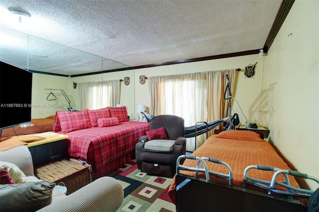 bedroom featuring a textured ceiling and crown molding