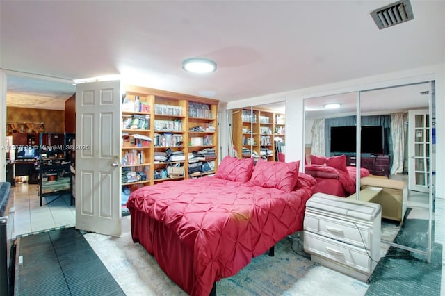 bedroom with visible vents and two closets