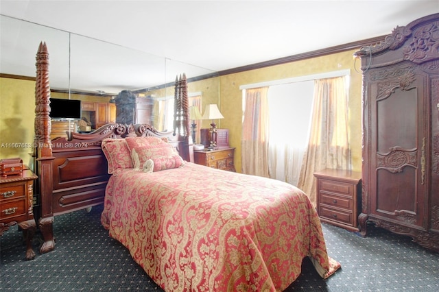 bedroom with dark colored carpet and crown molding