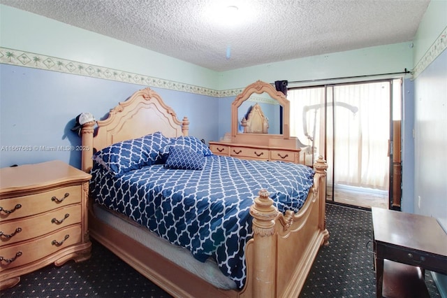 bedroom featuring dark colored carpet and a textured ceiling