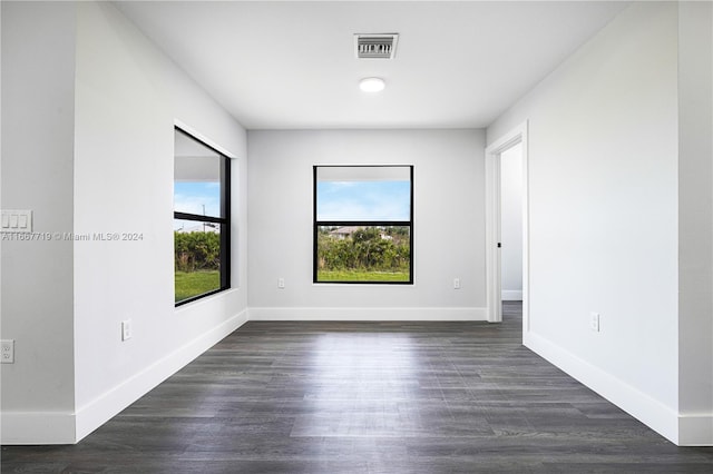 unfurnished room featuring dark hardwood / wood-style flooring