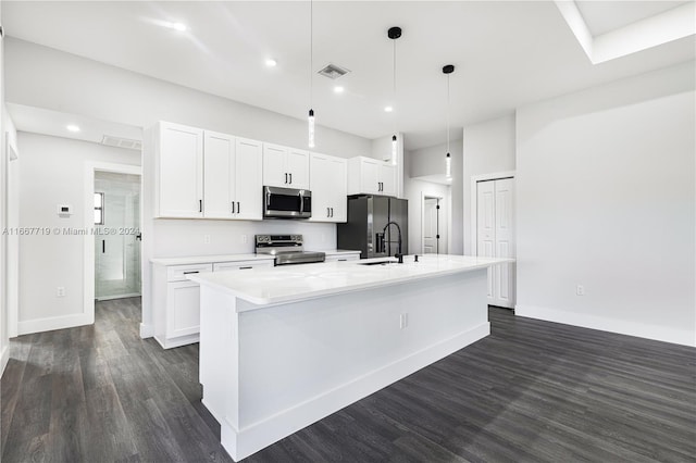 kitchen featuring a center island with sink, hanging light fixtures, stainless steel appliances, white cabinets, and dark hardwood / wood-style floors