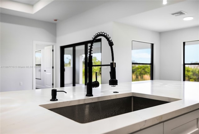 details featuring sink and white cabinetry