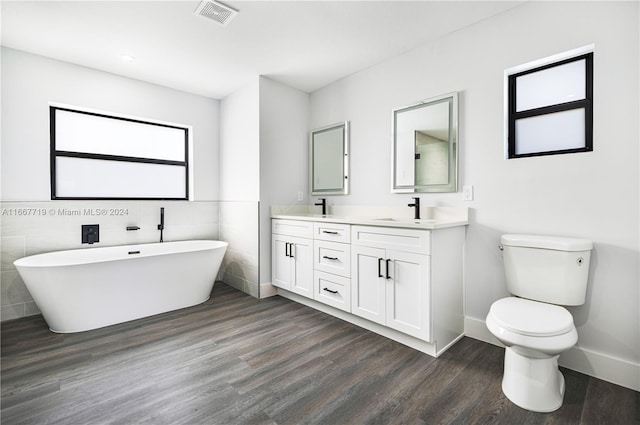 bathroom featuring vanity, tile walls, wood-type flooring, and toilet