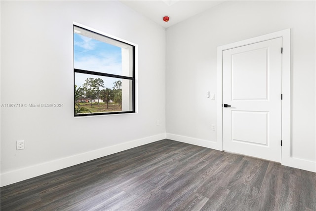 empty room featuring dark hardwood / wood-style flooring