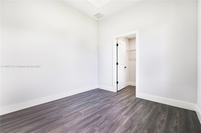 spare room with dark hardwood / wood-style flooring