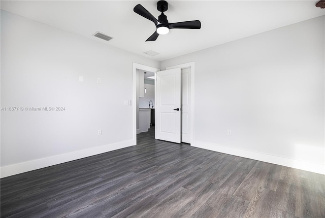 unfurnished bedroom with dark hardwood / wood-style floors and ceiling fan