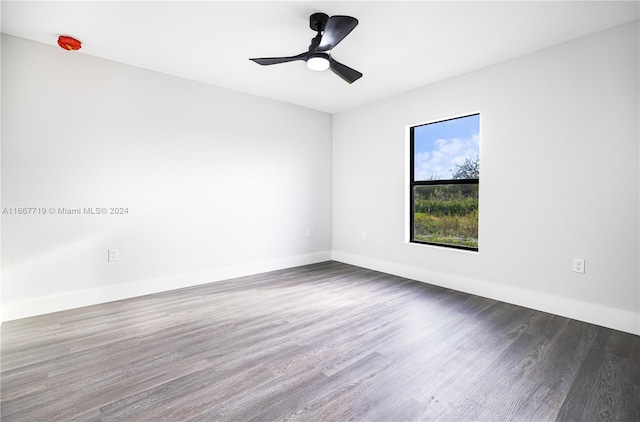 unfurnished room featuring ceiling fan and dark hardwood / wood-style flooring