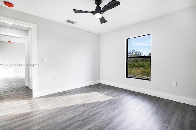 spare room with dark hardwood / wood-style floors and ceiling fan