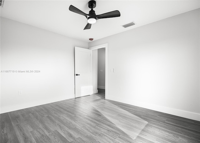 bathroom featuring vanity, toilet, wood-type flooring, and a shower with shower door