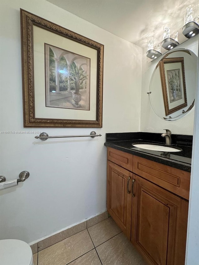 bathroom featuring vanity, toilet, and tile patterned floors