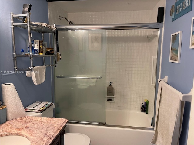 full bathroom with shower / bath combination with glass door, vanity, and toilet