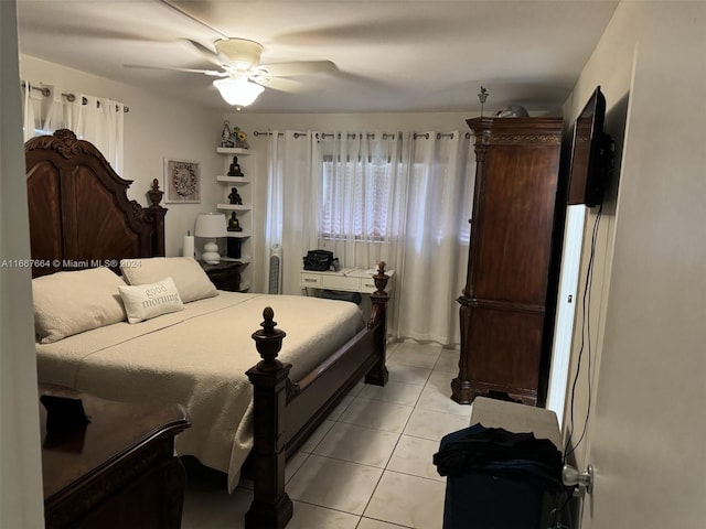 tiled bedroom featuring ceiling fan