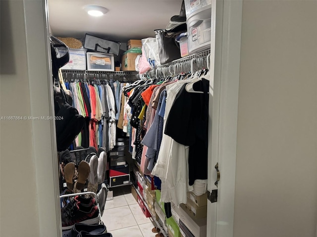 walk in closet with light tile patterned floors