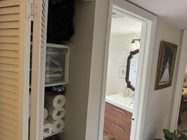 interior space with tile walls, hardwood / wood-style flooring, and vanity