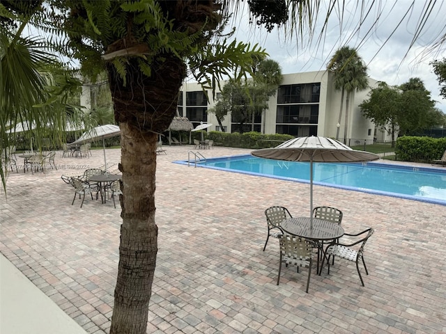 view of swimming pool with a patio area