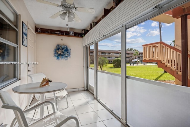 sunroom with a healthy amount of sunlight and ceiling fan