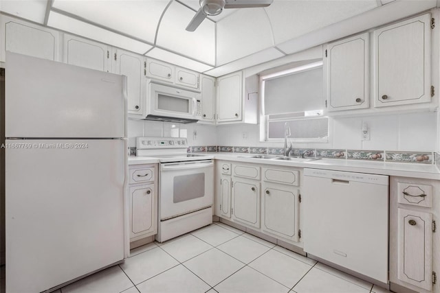 kitchen with sink, white cabinets, white appliances, light tile patterned floors, and ceiling fan