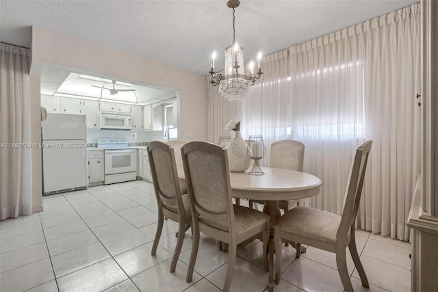 dining room featuring a notable chandelier, a textured ceiling, and light tile patterned flooring