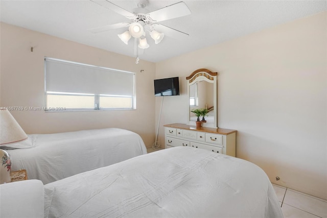 tiled bedroom with ceiling fan