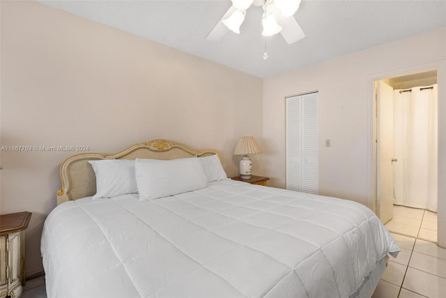 bedroom with light tile patterned floors, a closet, and ceiling fan