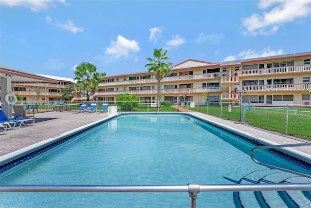 view of pool with a yard