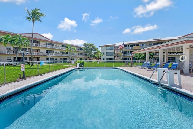 view of pool featuring a yard