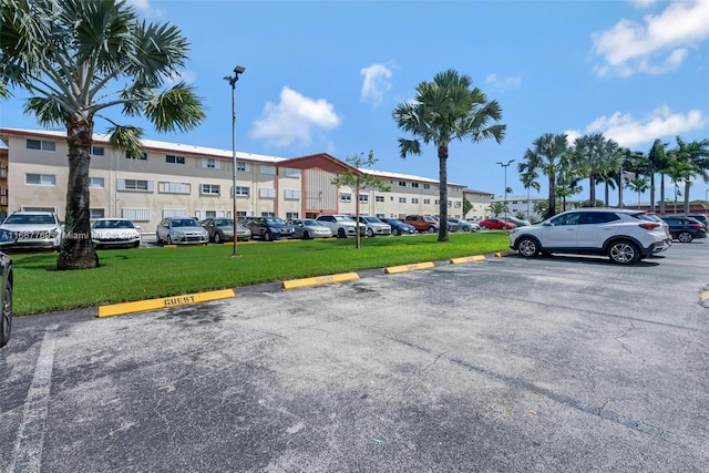 view of car parking with a lawn