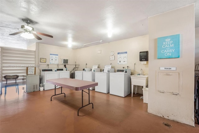 recreation room with a textured ceiling, concrete floors, separate washer and dryer, and ceiling fan