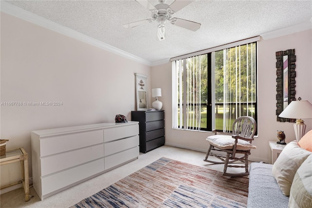 interior space with a textured ceiling, crown molding, and ceiling fan