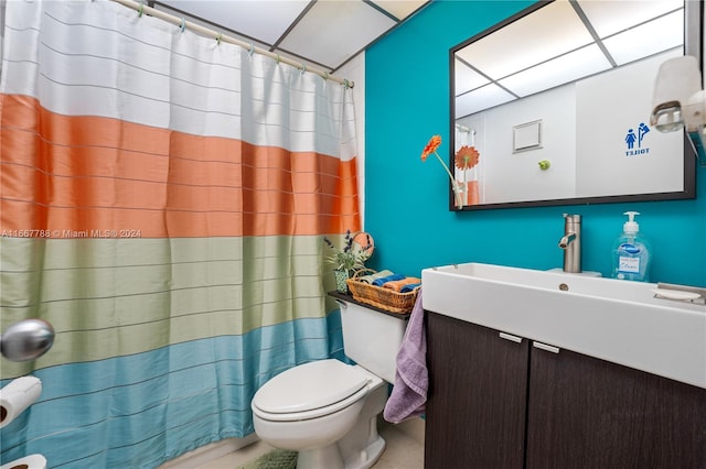 bathroom with walk in shower, vanity, and toilet