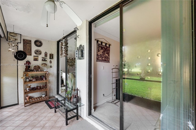 interior space with ceiling fan and light tile patterned flooring