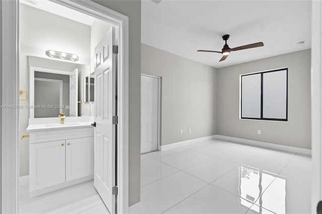 bathroom with tile patterned flooring, vanity, and ceiling fan