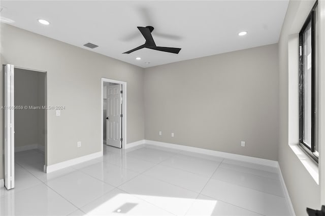 unfurnished bedroom with light tile patterned floors and ceiling fan