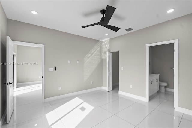 unfurnished bedroom featuring ceiling fan, light tile patterned flooring, and connected bathroom