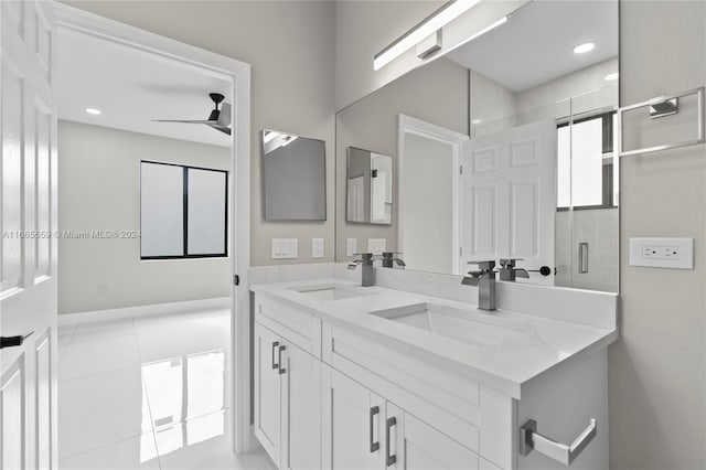 bathroom featuring a tile shower, tile patterned flooring, vanity, and ceiling fan