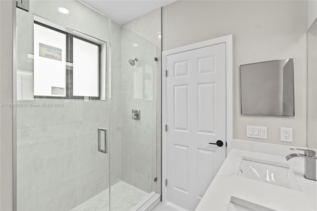 bathroom featuring vanity and an enclosed shower