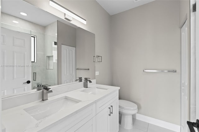 bathroom with walk in shower, vanity, toilet, and tile patterned floors