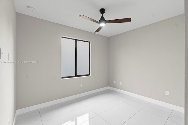 tiled empty room with ceiling fan