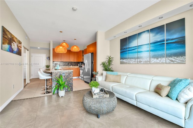 living room featuring light tile patterned floors and sink