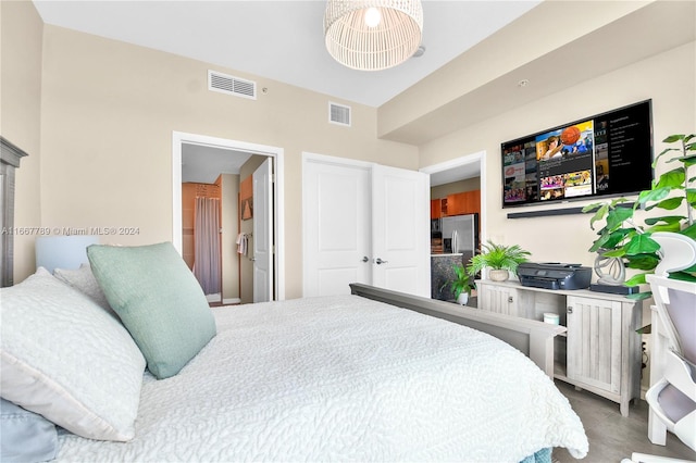 bedroom with stainless steel fridge