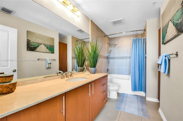 full bathroom with vanity, toilet, shower / bath combo with shower curtain, and tile patterned floors